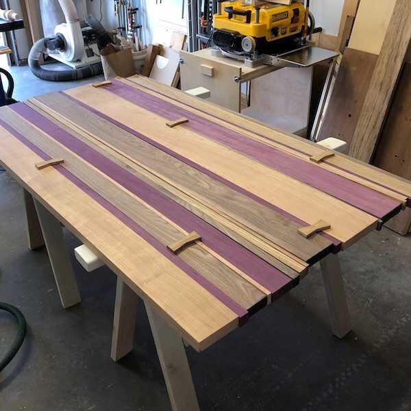 Custom wood dining table with bow ties